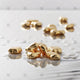 Gold Bullion Pellets on white - AI1006
