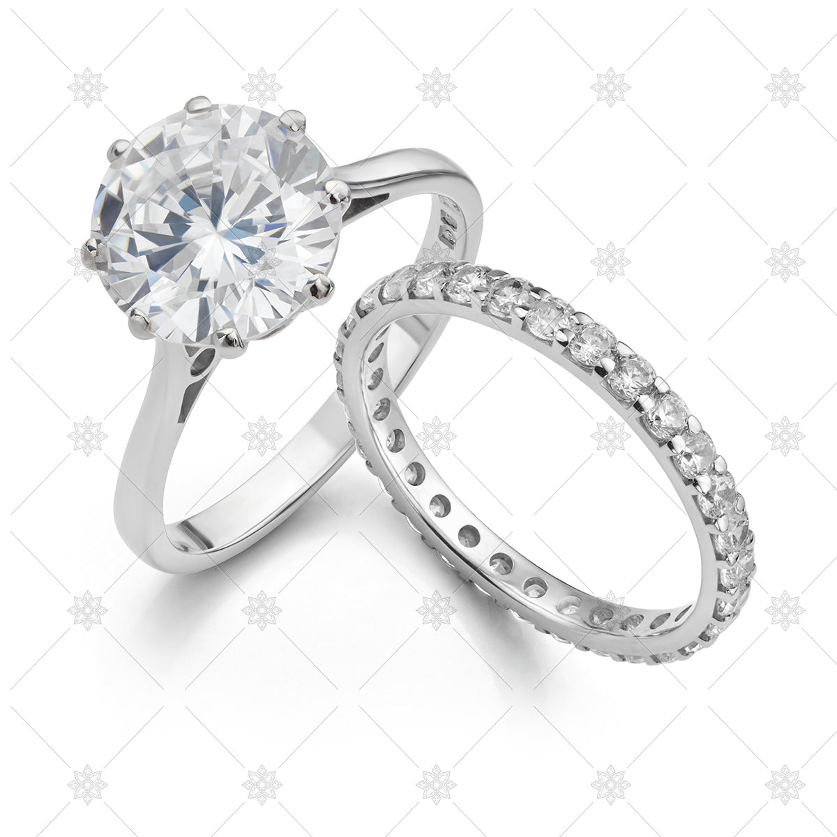 Jewellery stock photograph of a diamond solitaire engagement ring with a fully set diamond wedding ring isolated on a white background